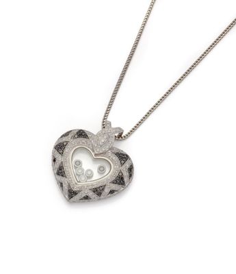 a close up of a heart shaped locke on a chain