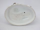 a white porcelain bowl with a hole in the middle