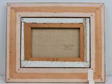 an old picture frame with a piece of paper taped around it
