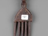 a wooden comb that has a tag on it