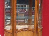 a wooden display case with a glass door on it