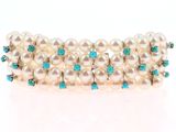 an image of a close up of a bracelet with pearls and turquoise stones