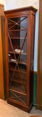 a wooden cabinet with a glass door in a room