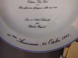 a white plate with a blue border and a gold border on it