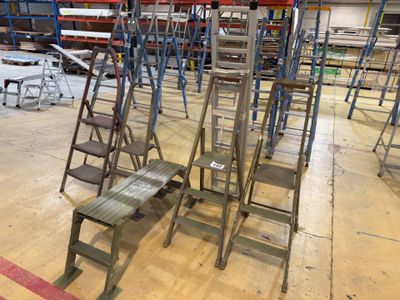 a lot of ladders that are sitting in a warehouse