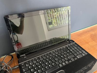 a laptop computer that is sitting on a desk