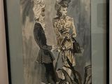 a framed picture of two people standing next to each other