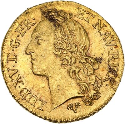 gros plan d'une pièce d'or portant un visage de femme