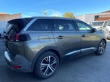 a grey suv parked in a parking lot next to a building