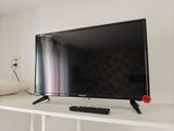 a flat screen tv sitting on top of a white shelf