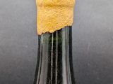 a close up of a bottle of wine with a cork stopper
