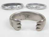 two silver rings with two different designs on them on a white surface