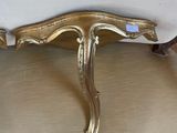 a gold table with a bird on top of it