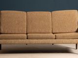 an image of a brown couch sitting on top of a white floor