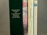 trois livres posés l'un à côté de l'autre sur une table