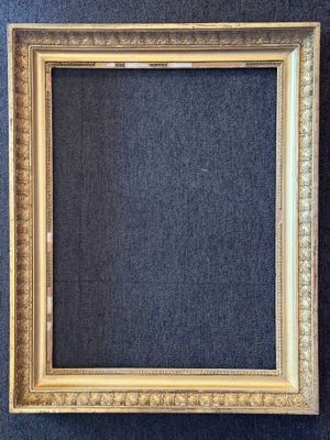 a gold frame on a blue carpet with a black background