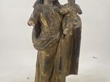 bronze statue of a woman holding a child in her arms