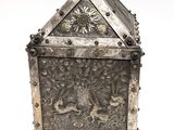 an old silver box with a design of a lion and flowers on it