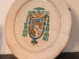 a white plate with a coat of arms on it