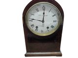 a wooden clock with roman numerals on the face