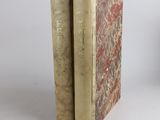 two books sitting on top of each other on a table