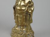 gold statue of a smiling buddha with a basket of flowers