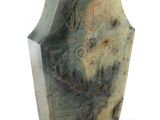 a green vase with a design on it on a white background