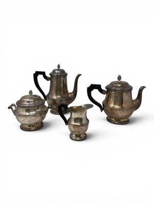 three pieces of silver tea and coffee set on a white background