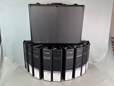 a lot of black binders stacked on top of each other