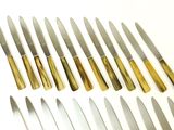 a lot of knives that are lined up on the table