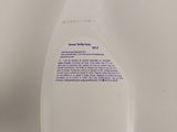 a close up of a bottle of hand sanitizer on a white surface