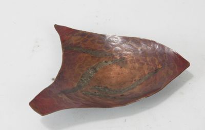 a red bowl with a brown and black design on it