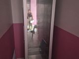 a person standing inside of a glass door in a room