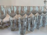 a lot of wine glasses and a pitcher on the table