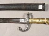 two different types of swords on display on a table
