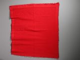 a close up of a piece of red fabric on a wall