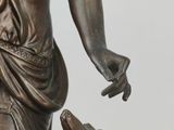 a statue of a woman with a dog on a table