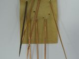 a piece of paper with a bunch of knitting needles on it