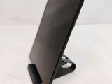 a black tablet on a stand on a white surface