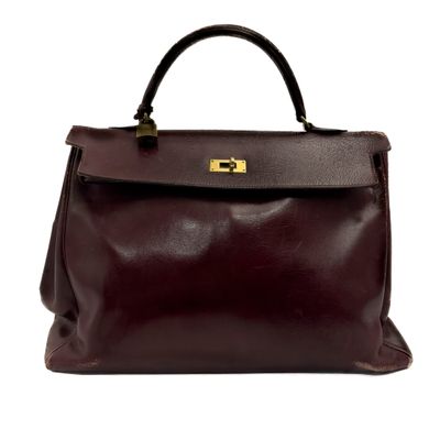 a brown leather handbag on a white background