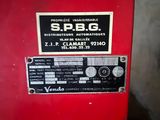 a red machine that has a sign on the side of it
