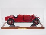 an old model of a red car in a clear display case