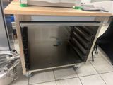 a microwave sitting on top of a cart in a kitchen