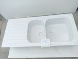 a white sink that is sitting on top of a table