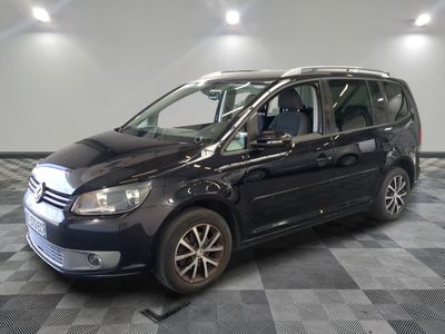the black van is parked on a checkered floor in the garage