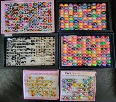 four boxes filled with different types of plastic beads