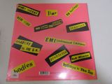 an image of a pink album with black and yellow stickers on it