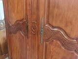 a large wooden armoire with ornate carvings on it