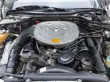 a car engine with the hood open on the street