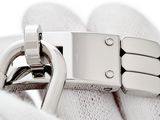 a close up of a person ' s hand holding a silver bracelet